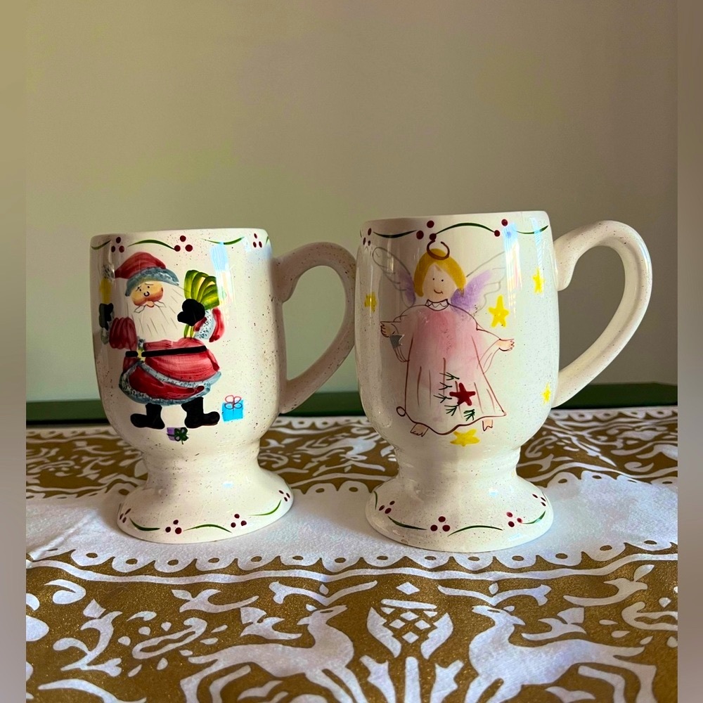 A pair of mugs featuring a Santa and an Angel.